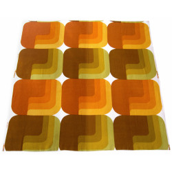 Geometric lozenge textile in muted greens and oranges